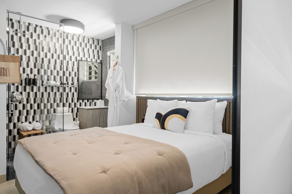 Escape to this tranquil haven featuring a queen-sized bed and a cozy bathroom