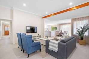 Living Room: Bright space with comfy seating and modern decor, perfect for relaxation and fun!
