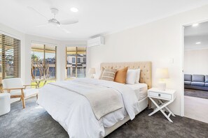 Master bedroom with king size bed, bedside tables and lamps