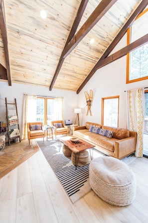 Climbing Bear | Angel Fire, New Mexico | Cozy Rocky Mountain Cabin | Spacious Open Floor Plan | Two Inviting Living Rooms | Main Living Room with a Stone Fireplace | Second Living Area for Additional Seating and Entertainment | Perfect for Family Gatherings or a Peaceful Retreat