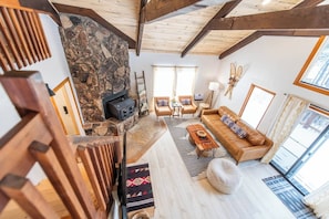 Climbing Bear | Angel Fire, New Mexico | Cozy Rocky Mountain Cabin | Spacious Open Floor Plan | Two Inviting Living Rooms | Main Living Room with a Stone Fireplace | Second Living Area for Additional Seating and Entertainment | Perfect for Family Gatherings or a Peaceful Retreat