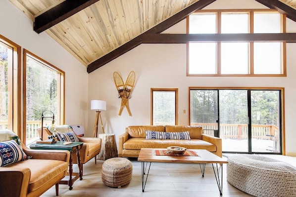 Climbing Bear | Angel Fire, New Mexico | Cozy Rocky Mountain Cabin | Spacious Open Floor Plan | Two Inviting Living Rooms | Main Living Room with a Stone Fireplace | Second Living Area for Additional Seating and Entertainment | Perfect for Family Gatherings or a Peaceful Retreat