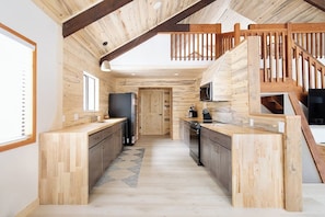 Climbing Bear | Easy Ski Access | Angel Fire, New Mexico | Cozy Rocky Mountain Cabin | Spacious Open Floor Plan | Inviting Living Room with Stone Fireplace | Fully Equipped Kitchen with Modern Appliances and Ample Counter Space | Expansive Deck for Enjoying the Fresh Mountain Air | Hot Tub and Fire Pit Coming October 1st | Perfect for Family Getaways or a Peaceful Retreat