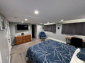 Bedroom with Queen Bed, Desk, and Reading Chair.