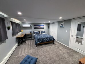 Bedroom with Queen Bed, Desk, and Reading Chair.