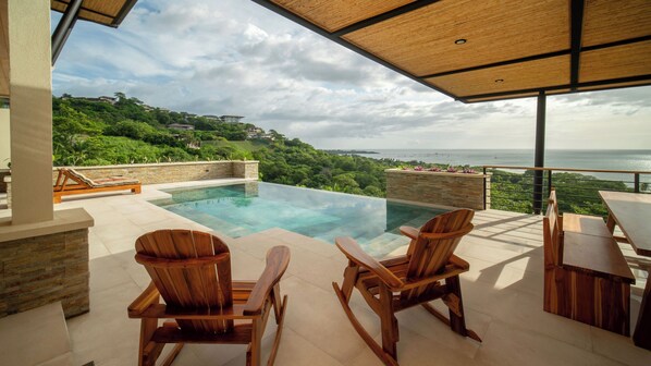 Oceanview outdoor area with infinity pool - Nestled atop the verdant hills of Tamarindo, behold a sanctuary offering panoramic ocean vistas and invigorating sea breezes.