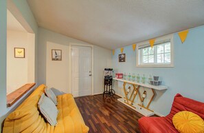 Multipurpose room with hardwood flooring, beverage cart, and floor couches