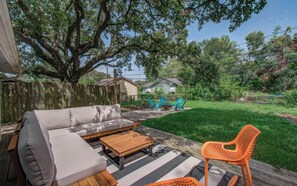 Patio with cozy lounge seating overlooking backyard