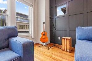Cozy music corner with a guitar and cajón—unwind and play!