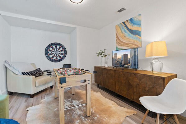 Game room space with smart tv, darts and foosball table