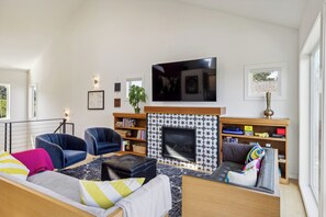 Living area with cozy gas fireplace and Smart TV.