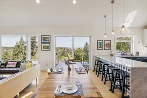 Large dining table with seating for up to 8, with additional seating at the bar.