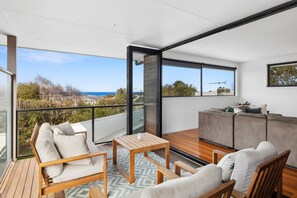 Bi-fold doors and expansive windows integrate indoor comfort with outdoor living
