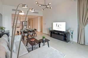 Living Area with 6 person dining table, sofa bed & 60 inch 4K smart TV