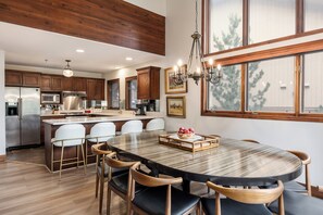 - Share meals around the spacious dining table with seating for ten & a glowing chandelier
- Fully equipped kitchen featuring stainless steel appliances & wood cabinetry
- Sip morning coffee at the breakfast bar with comfy stools & golden accents