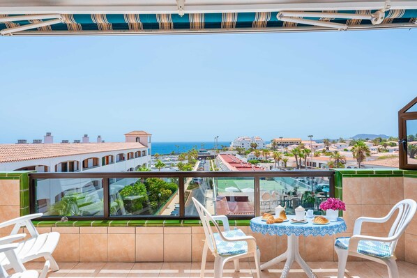 Balcony with Ocean View, Sun Loungers, Dining Table and Chairs