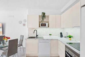 Kitchen with Dishwasher, Oven, Stovetop, Fridge, Microwave, Electric Kettle and Coffee Machine