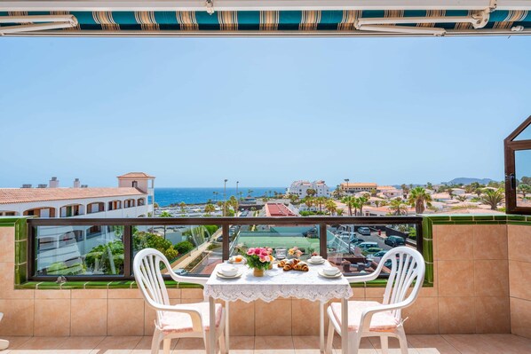 Balcony with Ocean View, Sun Loungers, Dining Table and Chairs