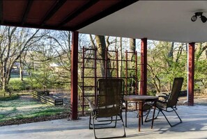 Unwind on the patio with a stunning view of the backyard, ideal for outdoor gatherings and peaceful moments.