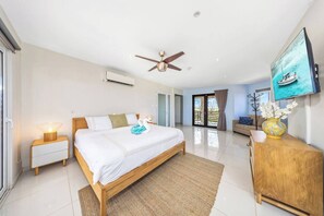 The master bedroom is a haven of comfort with a king bed, a TV, and a relaxing sofa. Enjoy your personal retreat with plenty of space to lounge and enjoy your favorite shows in style.