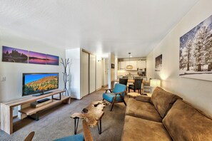The living room with sofa sleeper is just waiting for movie night on the HDTV