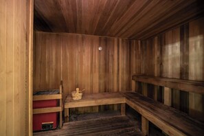Enjoy the soothing heat of the wood-paneled sauna, perfect for relaxation and detoxification.