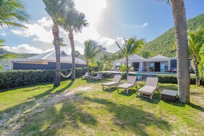 Beachfront property with a direct access on the beach.Nice beachfront garden with tropical flowers, palm trees.  Lounge chairs and hammock under the palm trees. Private parking at the entrance. 