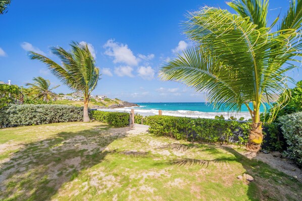 Beachfront property with a direct access on the beach.Nice beachfront garden with tropical flowers, palm trees. Lounge chairs and hammock under the palm trees. Private parking at the entrance.
