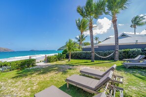 Beachfront property with a direct access on the beach.Nice beachfront garden with tropical flowers, palm trees. Lounge chairs and hammock under the palm trees. Private parking at the entrance.