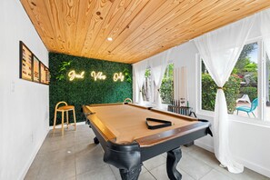 Pool table in the sun room / game room, overlooking pool area