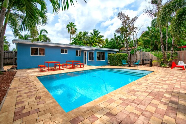Large pool with the al fresco dining area and different patio areas