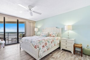 Oceanfront master bedroom with sliders to the balcony.Chairs just outside on the balcony for relaxing.