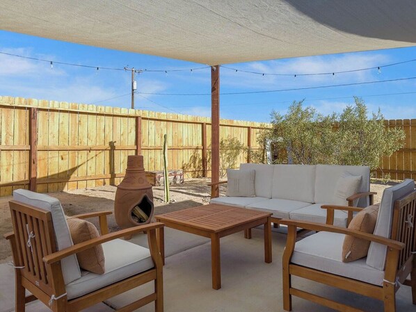 Gather around with friends and family in the perfect outdoor Airbnb fire pit and inviting outdoor seating area, where the desert breeze and serene surroundings set the perfect stage for memorable conversations and leisurely afternoons.