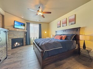 Master bedroom with California King bed, smart tv, and gas fireplace