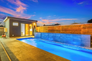 Private guest house with kitchen, TV, and stunning pool for ultimate relaxation.