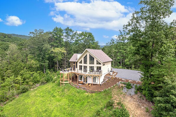 Nestled on a knoll in the mountain valley formed by two mountain ranges.