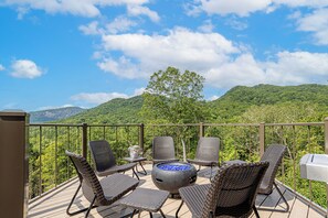 Hexagon deck that juts out into the mountain valley with gas firepit