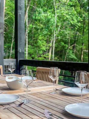 A beautiful outdoor dining setup on a wooden deck.