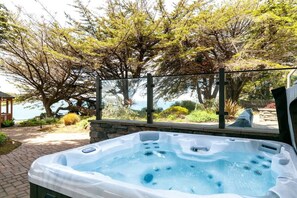 The hot tub is the perfect place to unwind with a cold beverage and a view. 