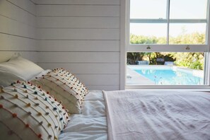 Wake up to poolside views in our tranquil and beautifully decorated bedroom