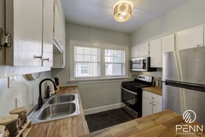 Cook up your favorite meals in this fully equipped kitchen, featuring modern appliances and plenty of natural light.