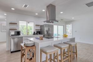 Fully equipped kitchen with barstool seating.