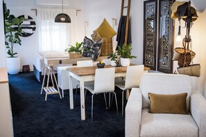 Open plan living, dining and bedroom with adjoining kitchen