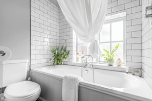 The property features a relaxing bathtub, perfect for unwinding after a long day and enjoying a soothing soak