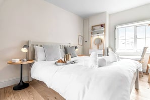 Bedroom 1 features a comfortable double bed with fresh linens, offering a cosy and restful space for a good night's sleep