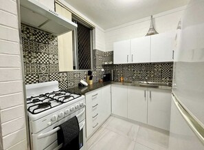 Full kitchen, Gas Stove top and oven, Piccolo coffee machine, Kettle, Toaster, Microwave, full fridge plus all you need to make a meal. 