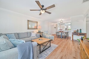 CIN5001 - Living with TV and sliding doors opening up to the screened on patio