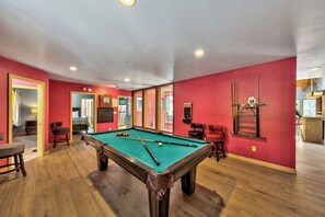 Pool table and dart board in the game room with plenty of space