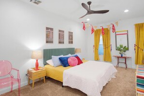 Bedroom with plush bedding, king bed, ceiling fan, and carpeted flooring
