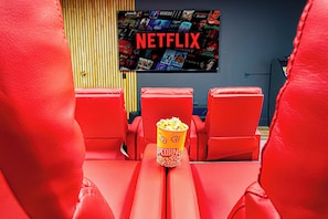 Enjoy a movie on the impressive 98-inch TV for the ultimate viewing experience.
